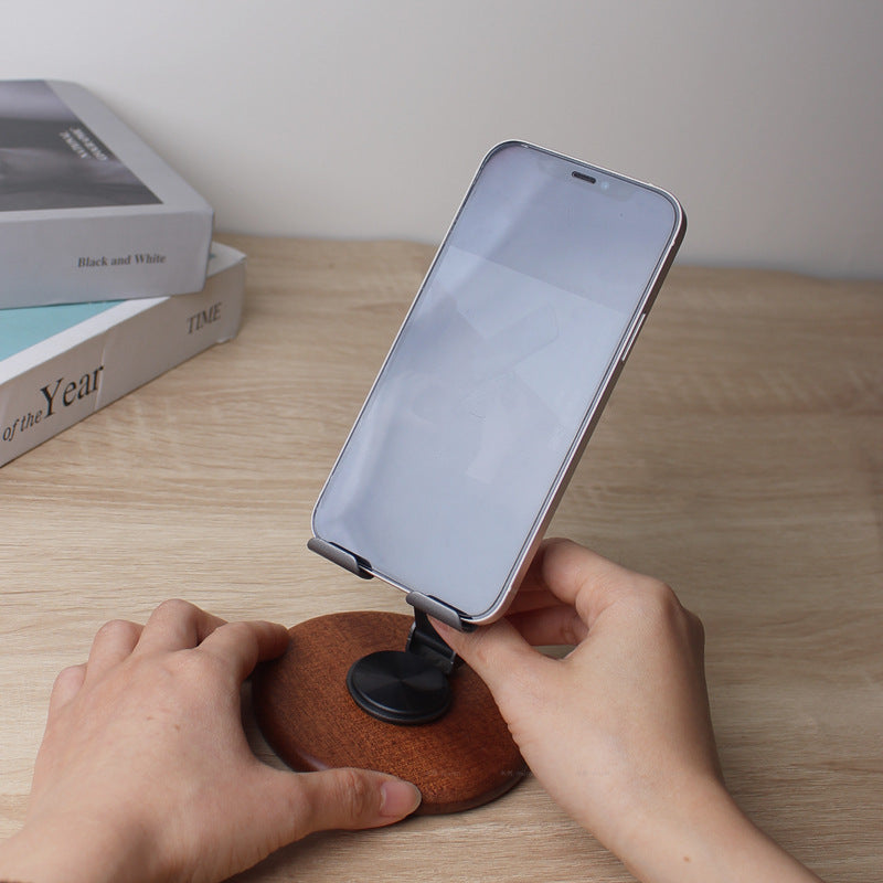 The new solid wood desktop mobile phone holder rotates 360 degrees, and the live broadcast is lazy and convenient to fold. Universal mobile phone holder